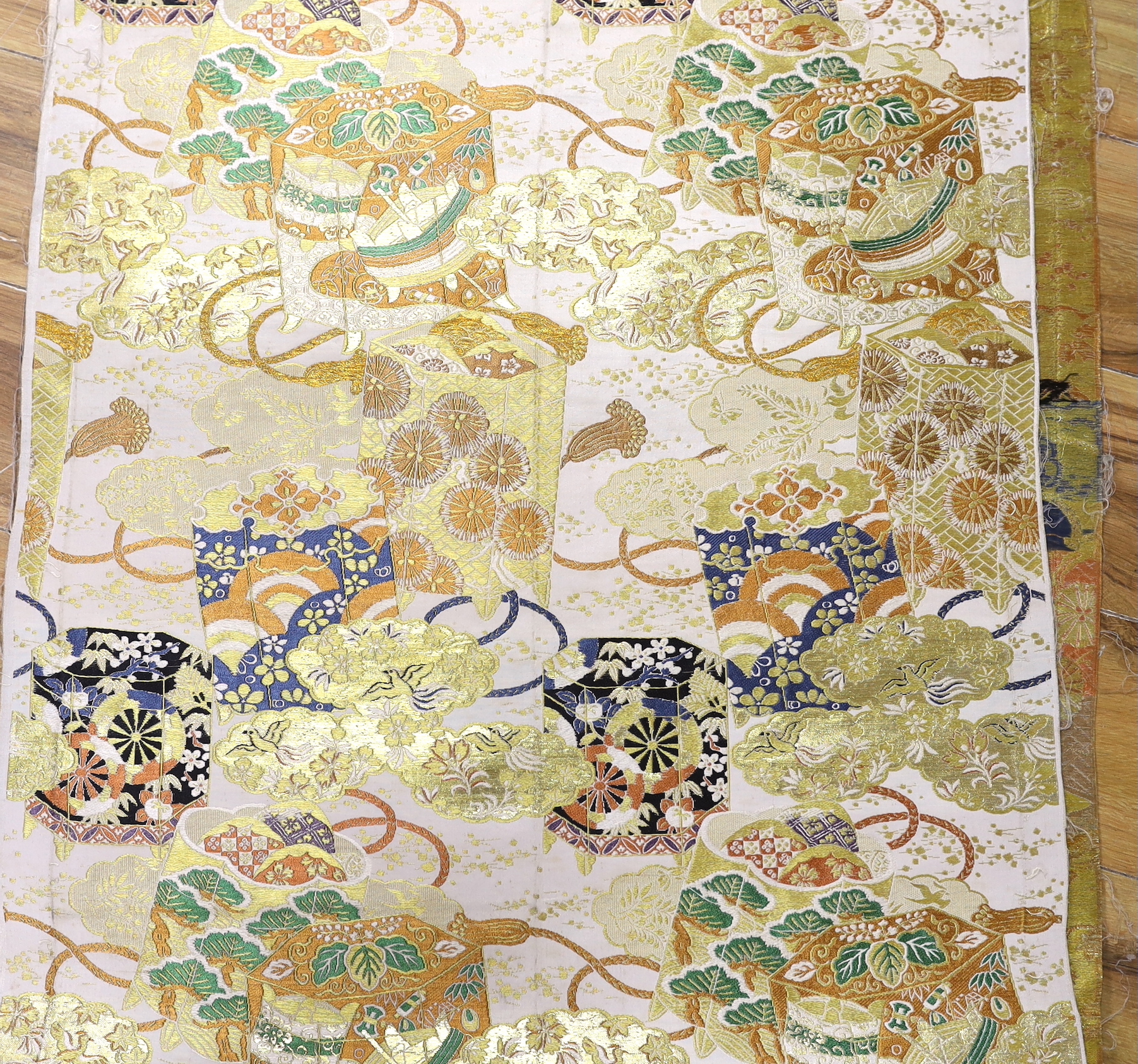 A roll of Japanese brocade fabric, (possibly for an Obi) and a framed Chinese silk embroidered child’s collar, collar 27cm diameter